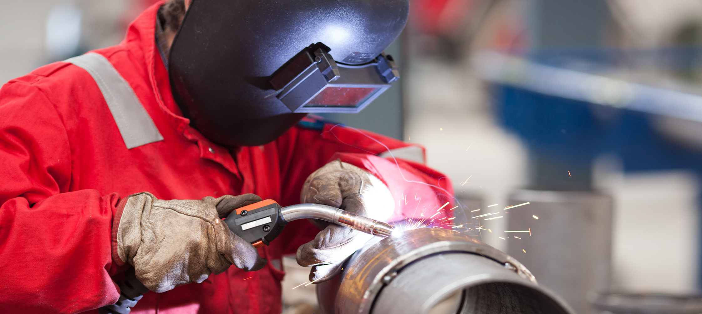 Welder with protective mask welding metal and sparks – National ...